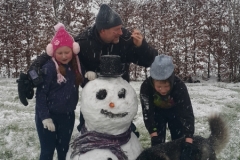 James, Toby, Zara and Alaska posing with the Snowman
