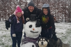 James, Toby, Zara and Alaska posing with the Snowman